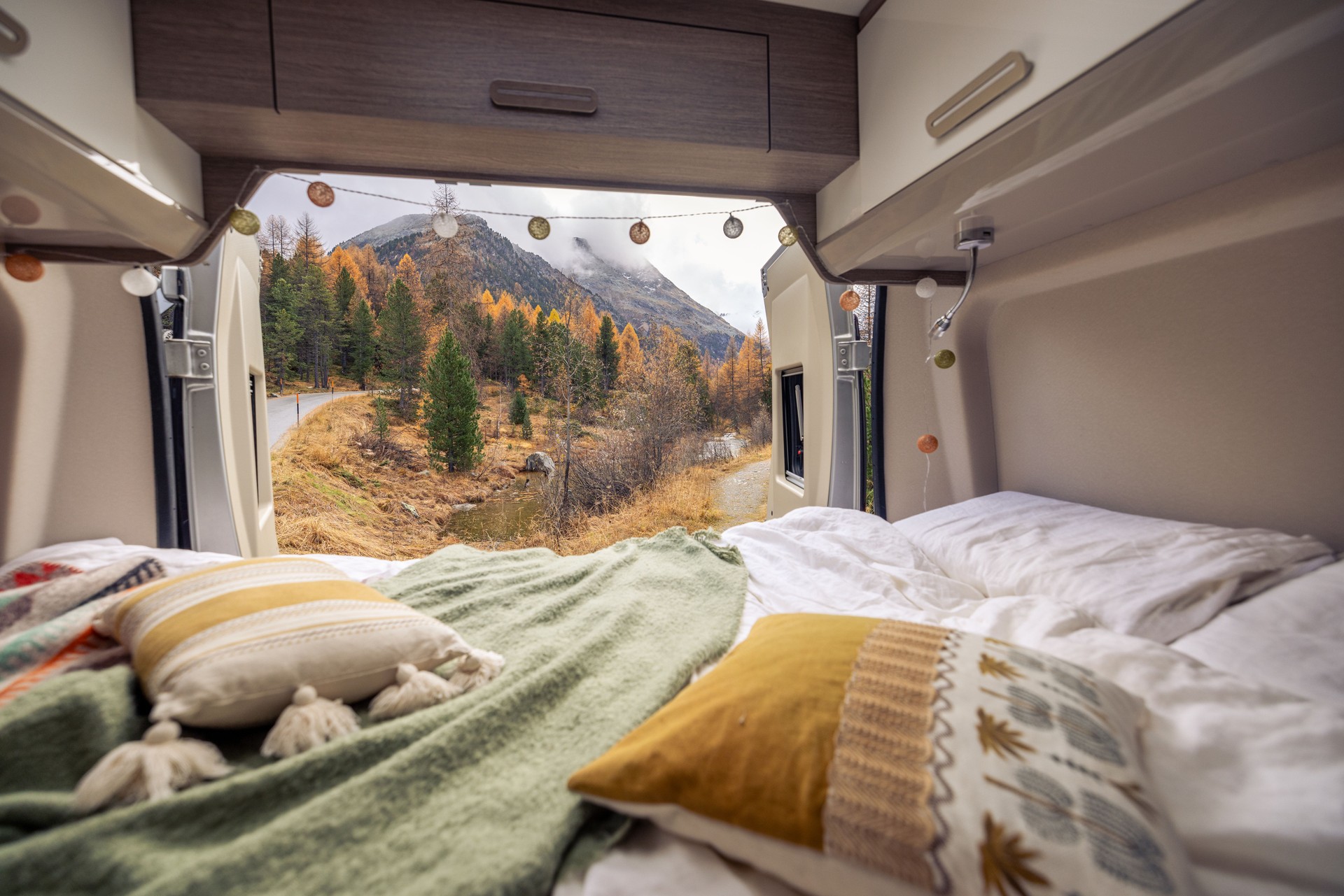Cozy Camper Van Interior with Scenic Autumn Mountain View
